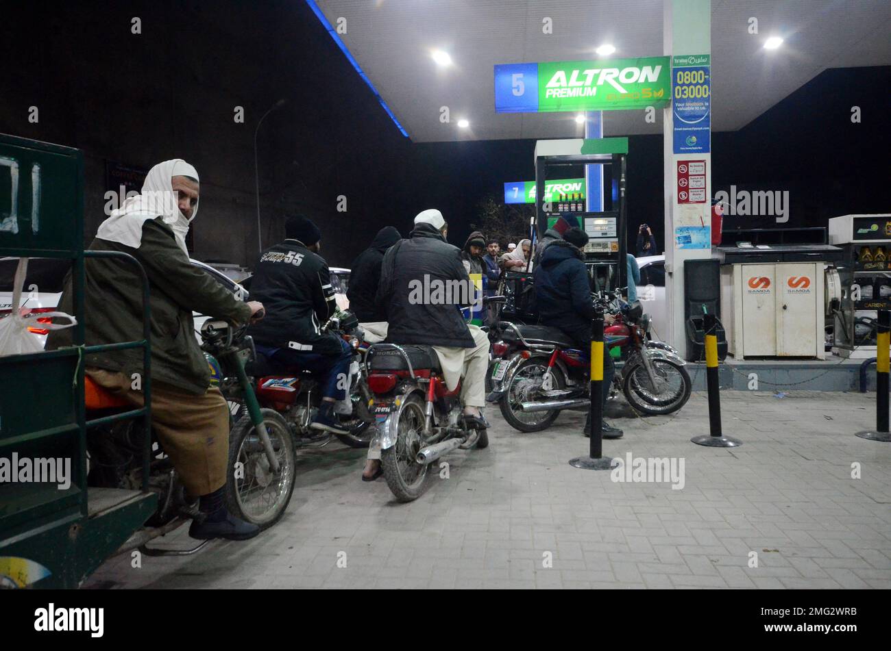 La gente espera su turno para conseguir combustible en una gasolinera, un día después de una avería eléctrica en todo el país. El lunes se presenciaron largas colas de automóviles y motocicletas en las estaciones de servicio en la mayor parte de Khyber Pakhtunkhwa, incluida la capital, tras una reducción en los suministros por parte de las empresas comercializadoras de petróleo. Después de la crisis del petróleo, hay largas colas de vehículos en las gasolineras de G.T Road. Gran parte de Pakistán se quedó sin electricidad el lunes debido a que una medida de ahorro de energía del gobierno fue contraproducente. La interrupción del servicio propagó el pánico y suscitó preguntas sobre la ha del gobierno con escasez de efectivo Foto de stock