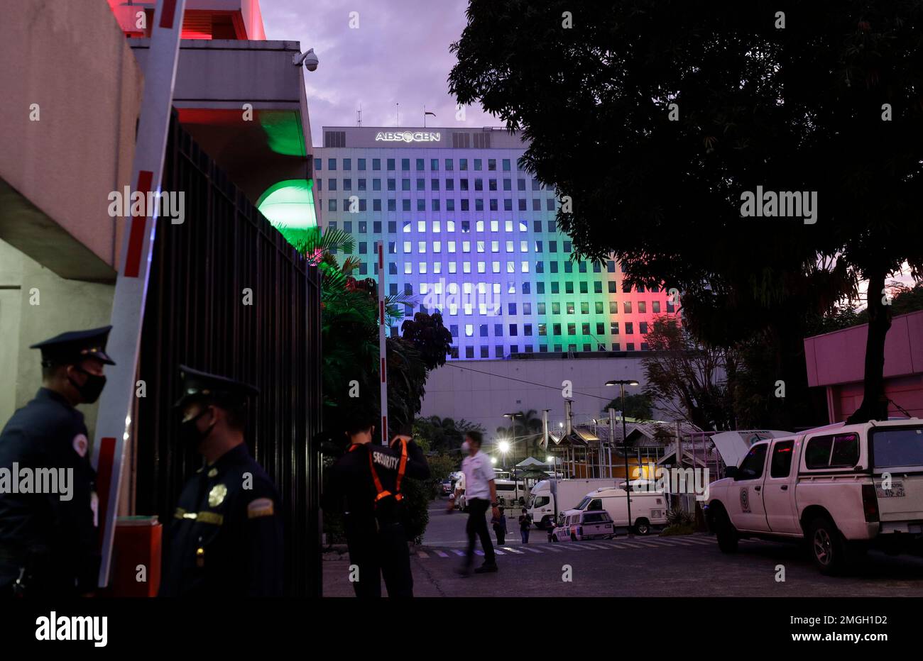 Security guards stand outside the headquarters of broadcast network ABS