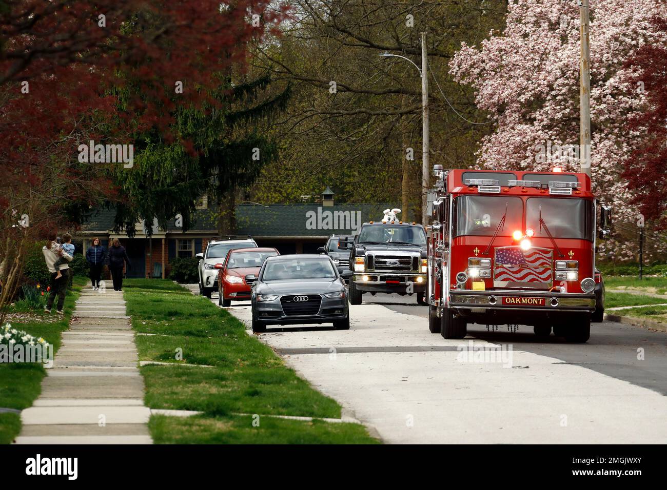 Kait French, of Havertown, dressed as the Easter Bunny, waves to