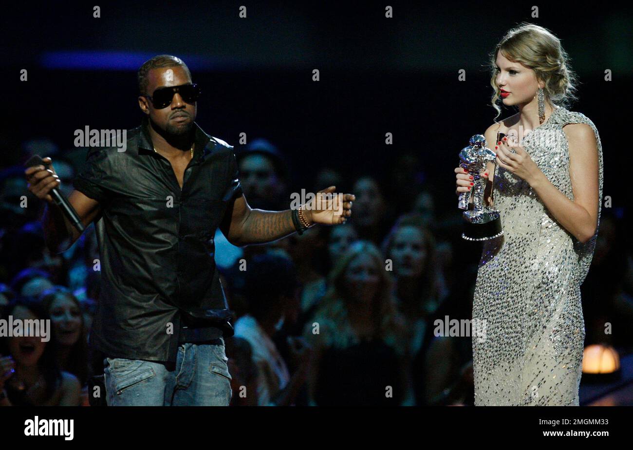 FILE - In this Sept. 13, 2009 file photo, singer Kanye West takes the  microphone from singer Taylor Swift as she accepts the "Best Female Video"  award during the MTV Video Music