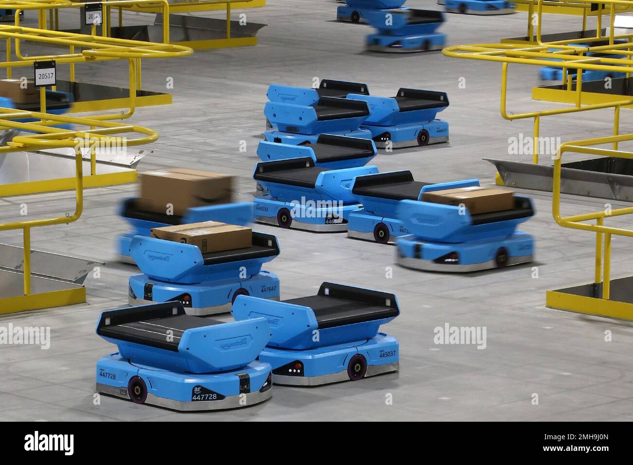 In this Dec. 17, 2019, photo Amazon robots zip along the a warehouse