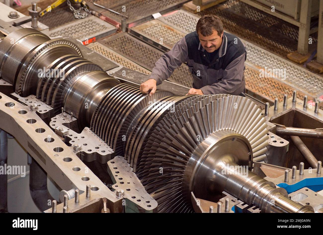 FILE In this Oct. 14, 2009 file photo an employee of MAN Turbo