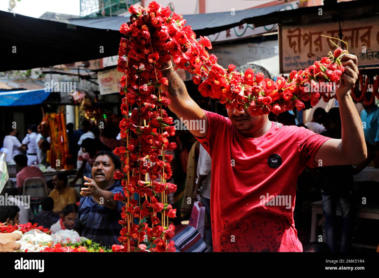 Vendors sell floral garlands outside Hindu goddess Kali temple on