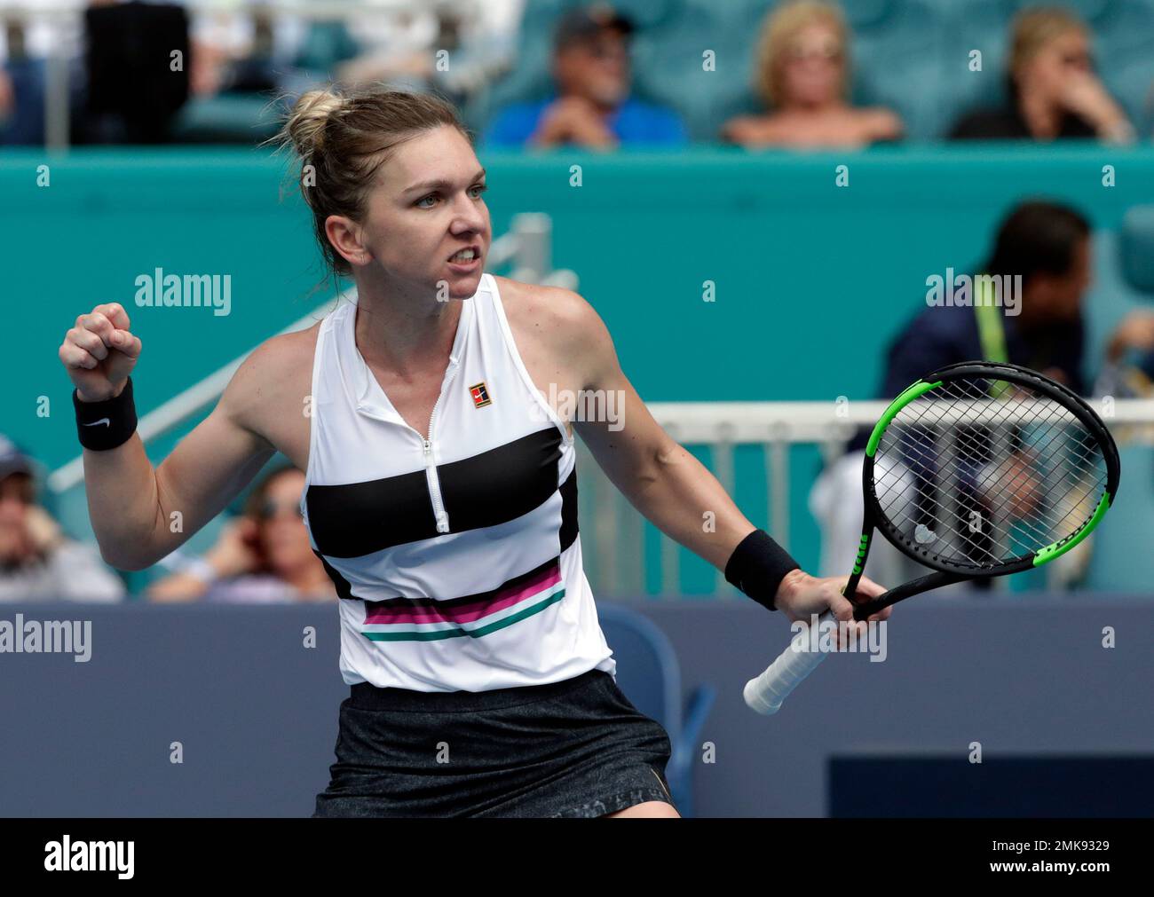 Simona Halep, of Romania, reacts after winning the second set against