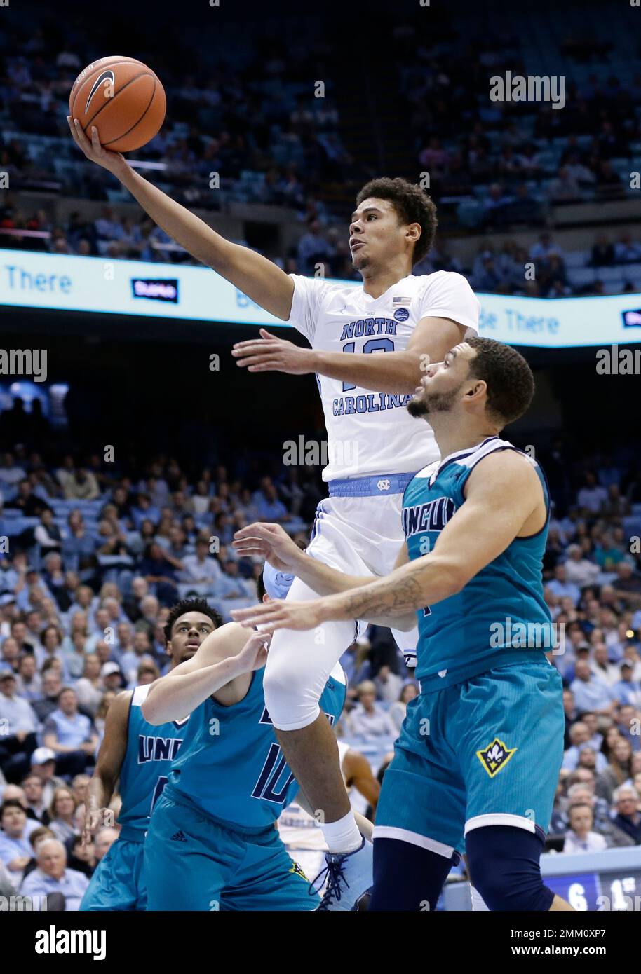 North Carolina's Cameron Johnson (13) drives to the basket against UNC