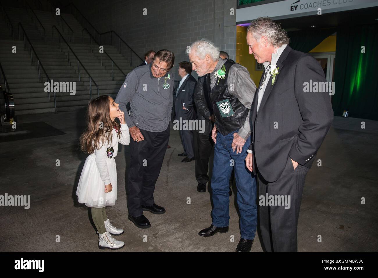 Don Maynard, left, and Joe Namath, center, joke with a member of Weeb  Ewbank's family during the Ring of Honor induction as the Jets faced  the New York Giants at the New