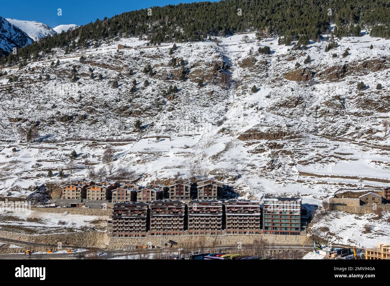 Urbanización de casas de montaña en la ladera de la montaña nevada en los Pirineos, Andorra. Foto de stock