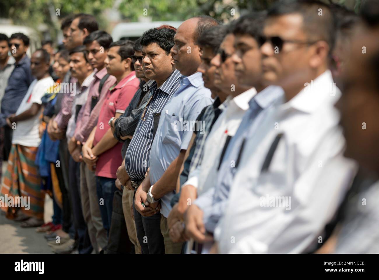 Bangladeshi journalists observe a minute's silence to pay homage to the