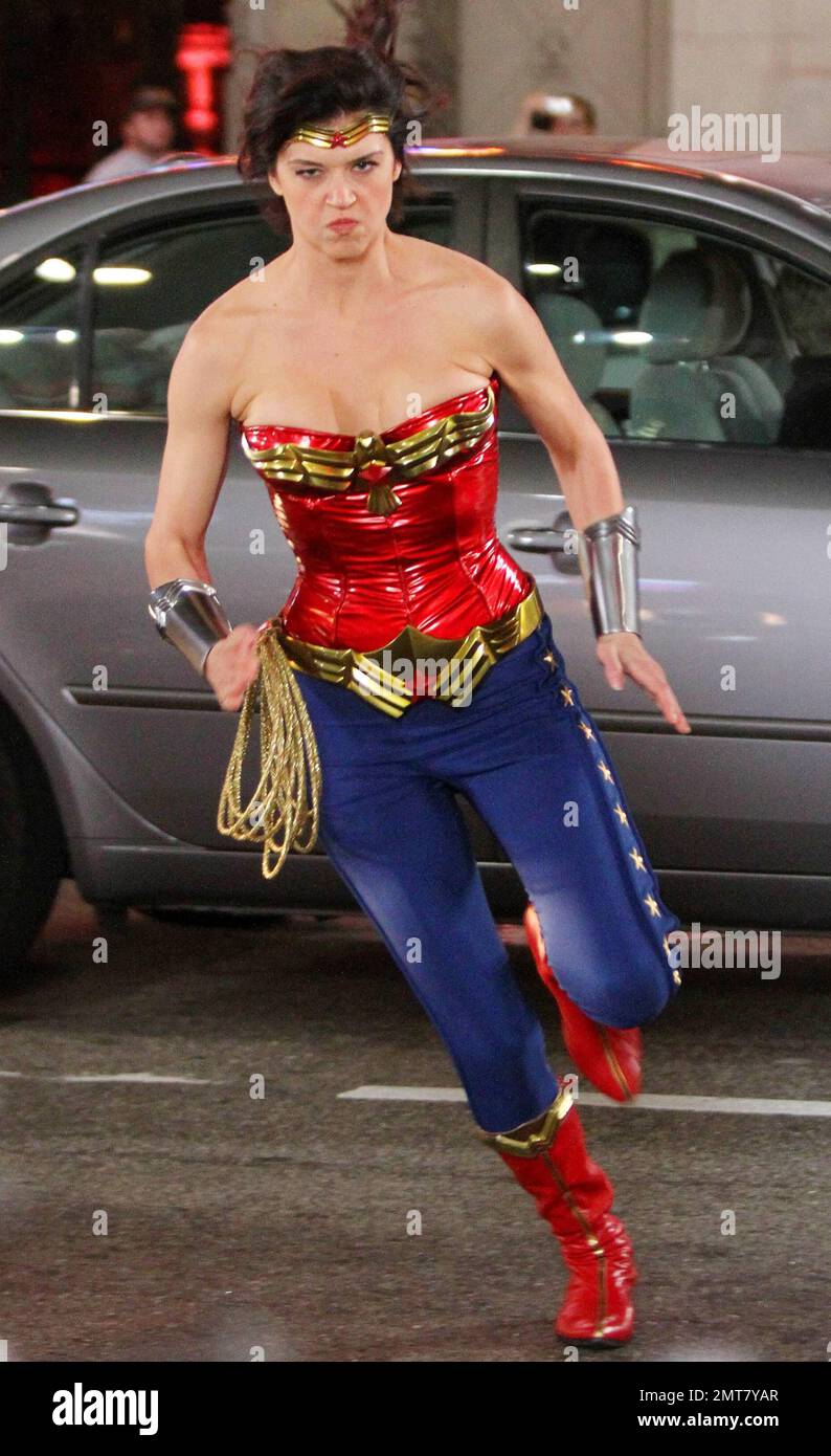 Adrianne Palicki corre alrededor del set y muestra su figura con su icónico  disfraz de Wonder Woman de un top de cuero azul brillante y leggings azules  con detalles de estrellas durante