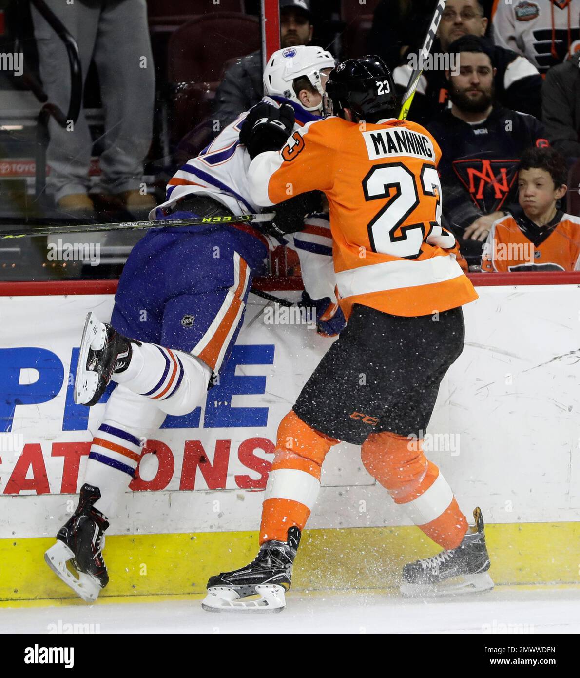 Philadelphia Flyers' Brandon Manning, right, checks Edmonton Oilers' Connor McDavid during the