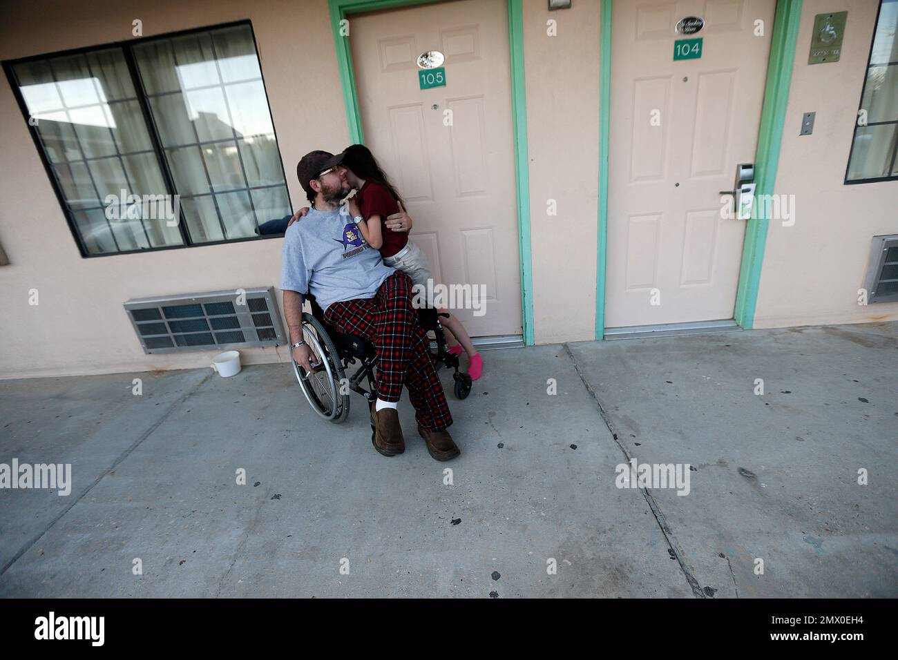 Daniel Howell, a paraplegic, hugs his daughter Abigail, 11, after she