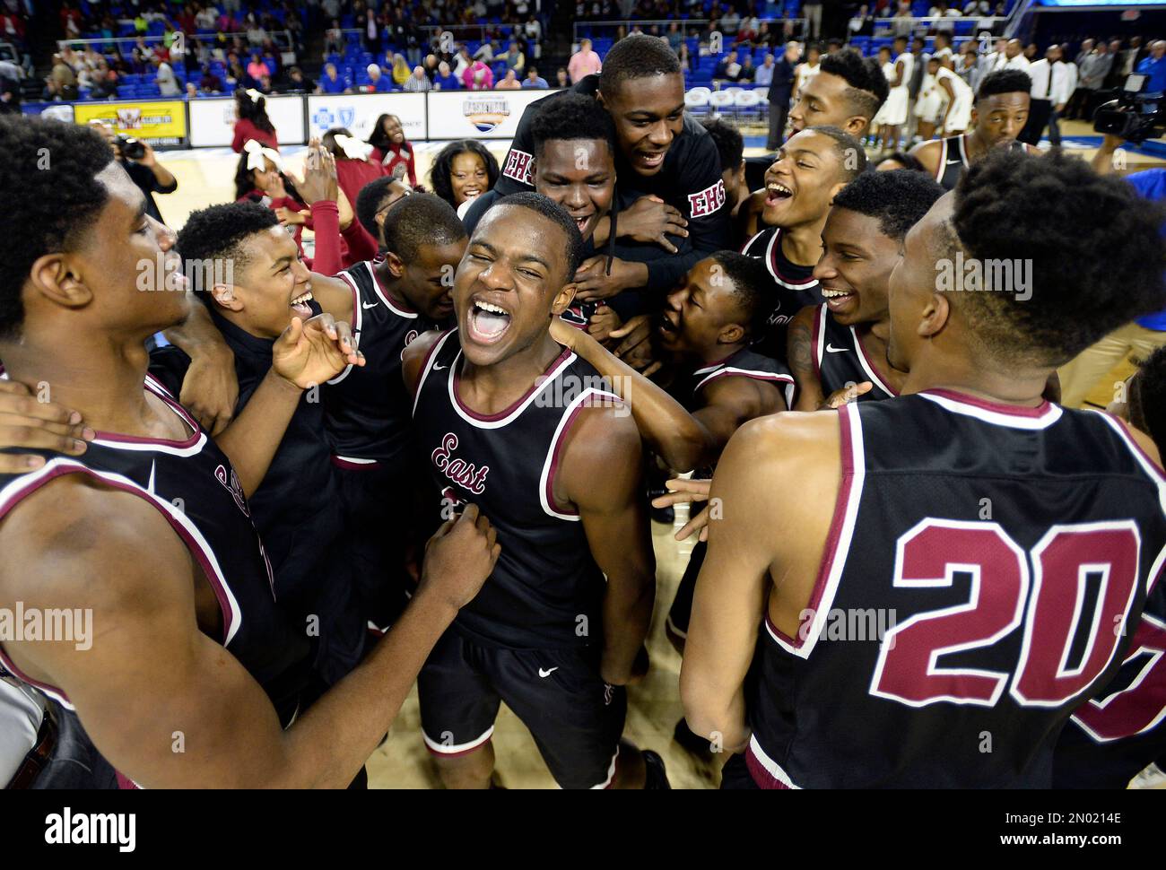 Memphis East guard Alex Lomax, center, celebrates with his teammate