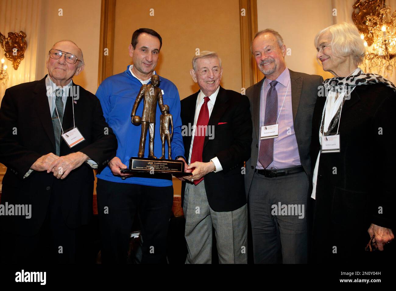 Duke University basketball coach Mike Krzyzewski, second left, winner