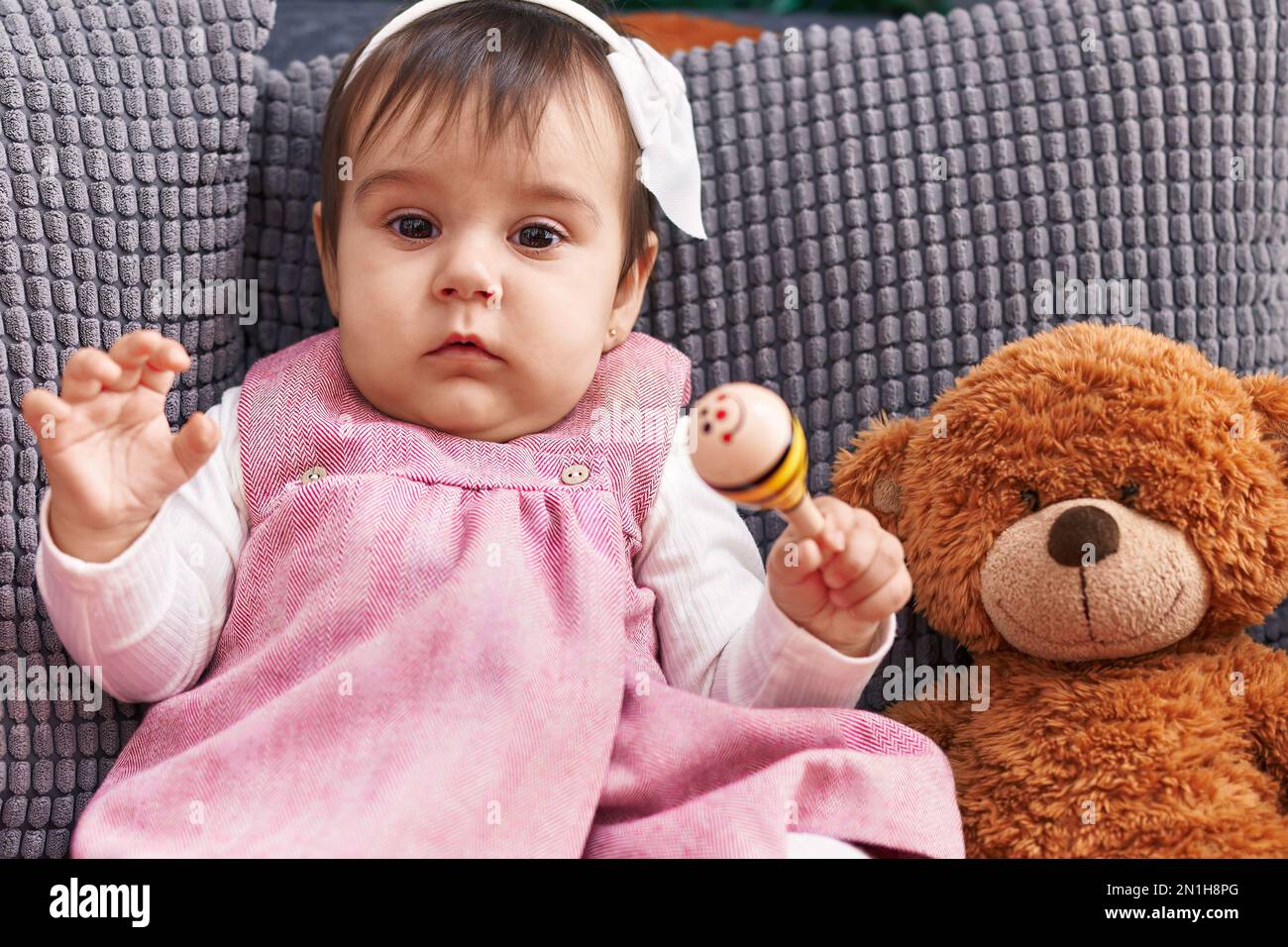 Bebé sentado en el sofá Fotografía de stock - Alamy