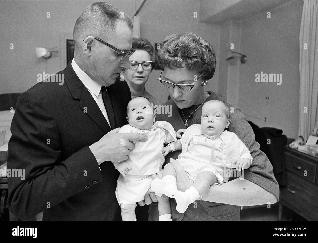 Andrew Fischer and his wife Mary Ann Fischer hold two of their