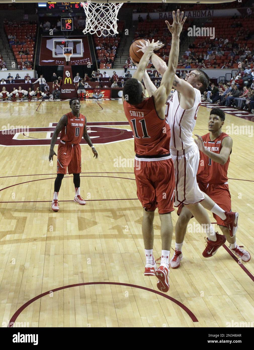 Oklahoma forward Ryan Spangler, right, shoots as Texas Tech forward
