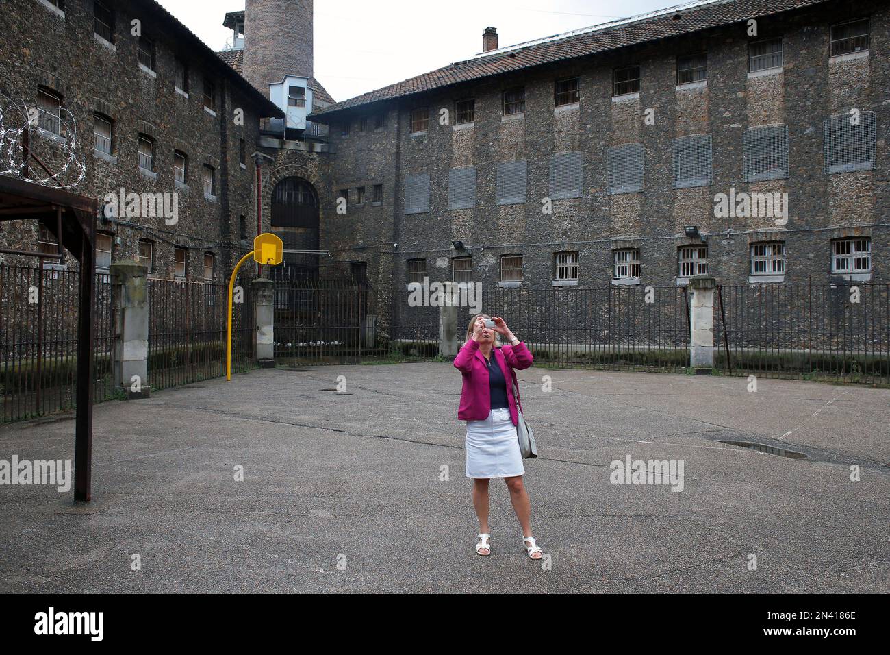 A woman takes a snapshot as she visits La Sante prison, in Paris ...