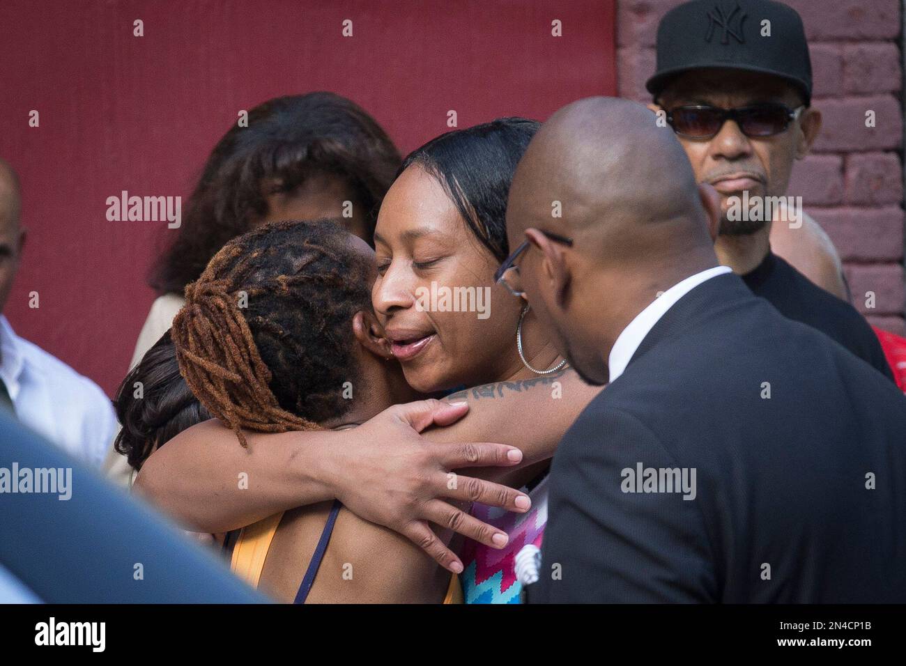 Ellisha Flagg, sister of Eric Garner, center, arrives at the funeral