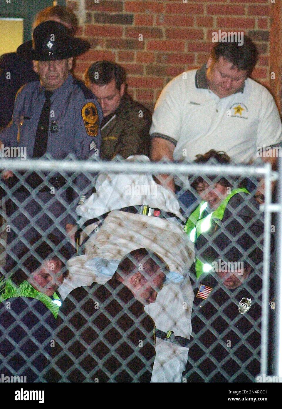FILE In this Jan. 16, 2002 file photo, police and emergency personnel carry a body of a victim