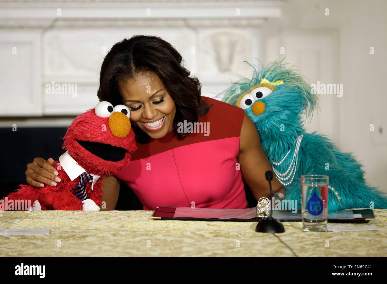 First lady Michelle Obama, center, with PBS Sesame Street's characters