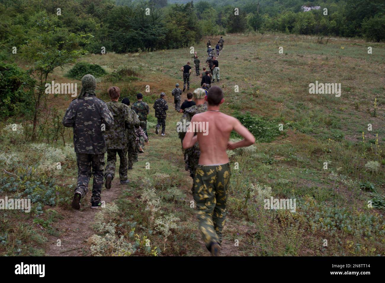 Participants in a youth military camp have training at their camp, some