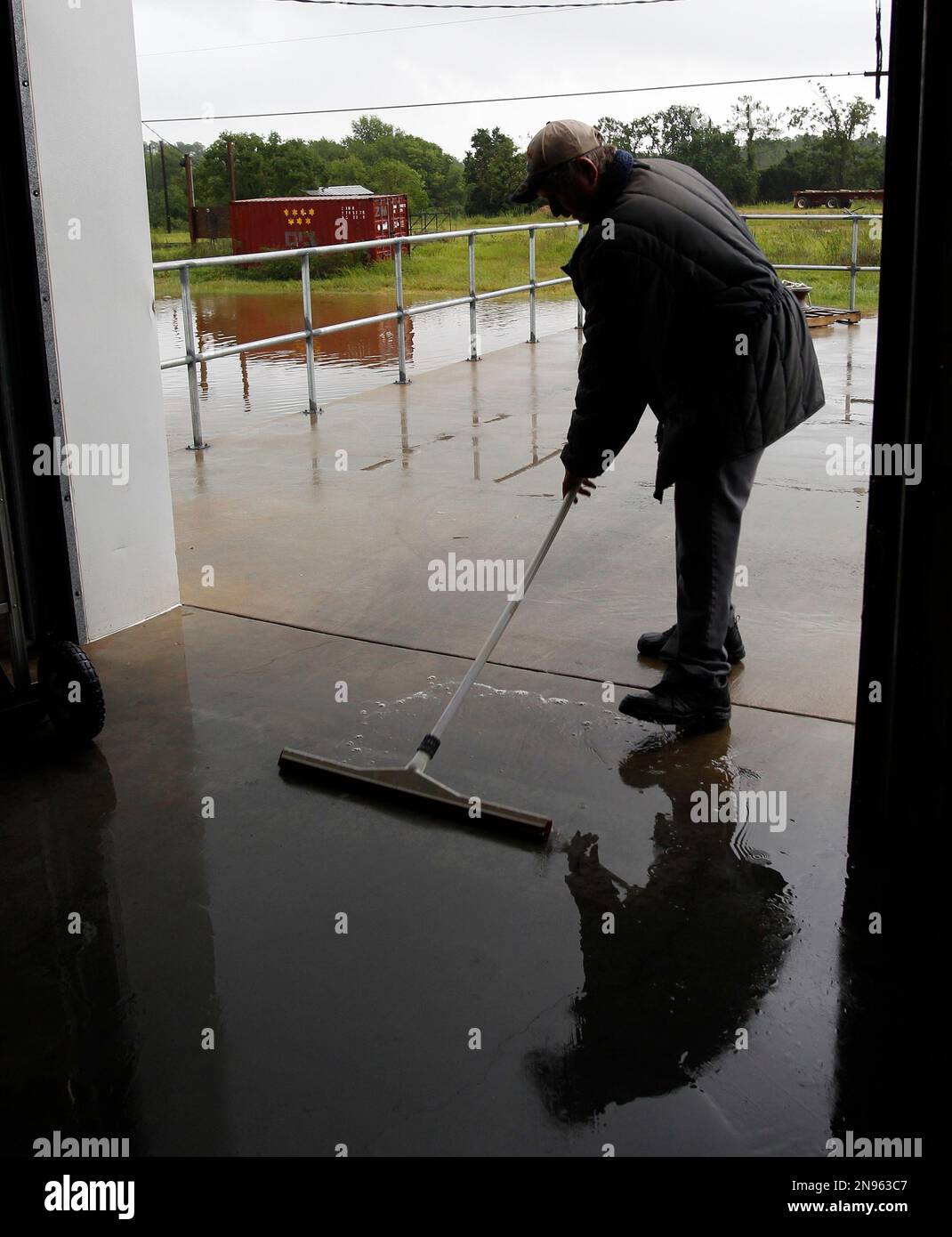 Jerry Barber sweeps out water from inside the Dominick Seafood plant