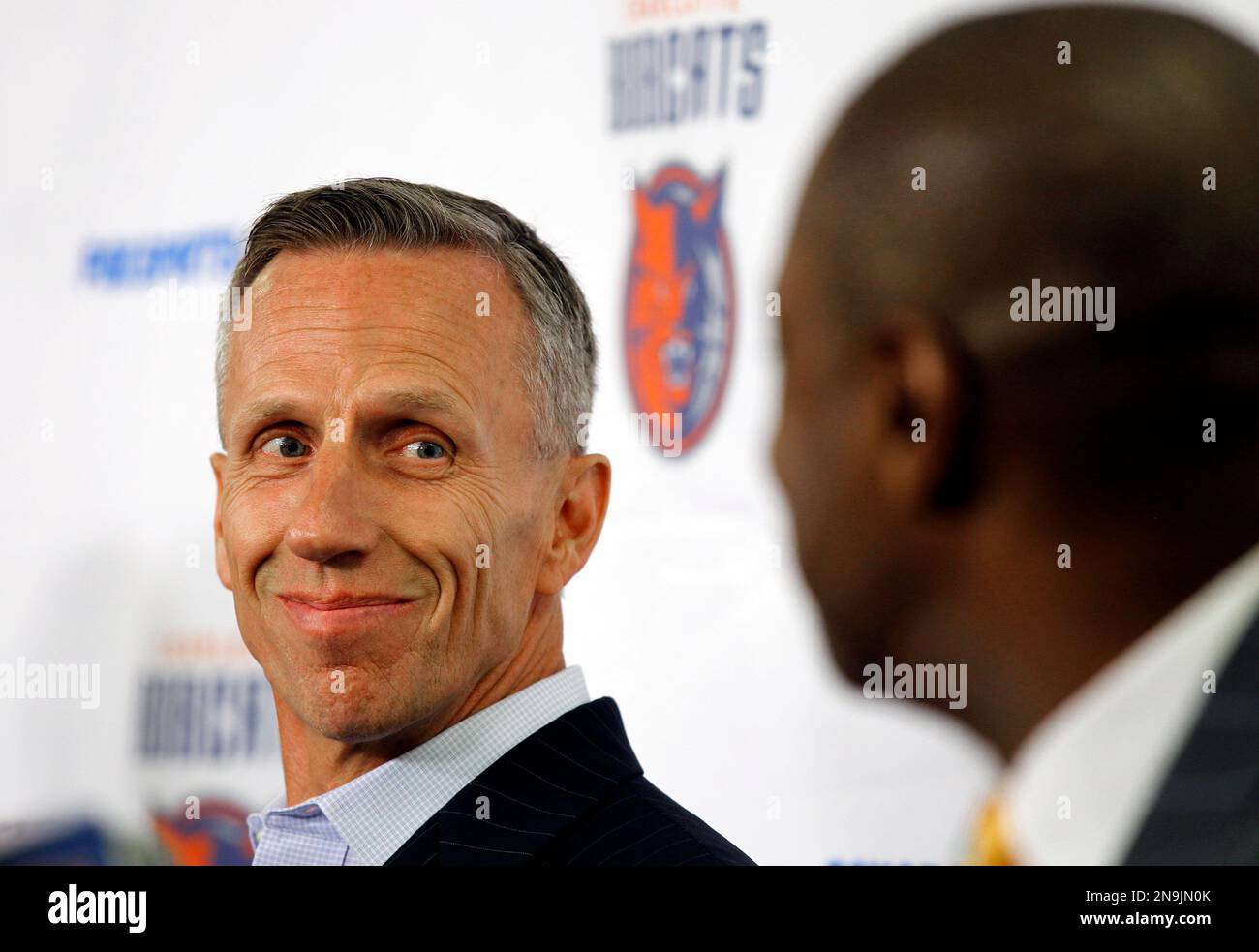 Charlotte Bobcats head coach Mike Dunlap, left, smiles at Rod Higgins