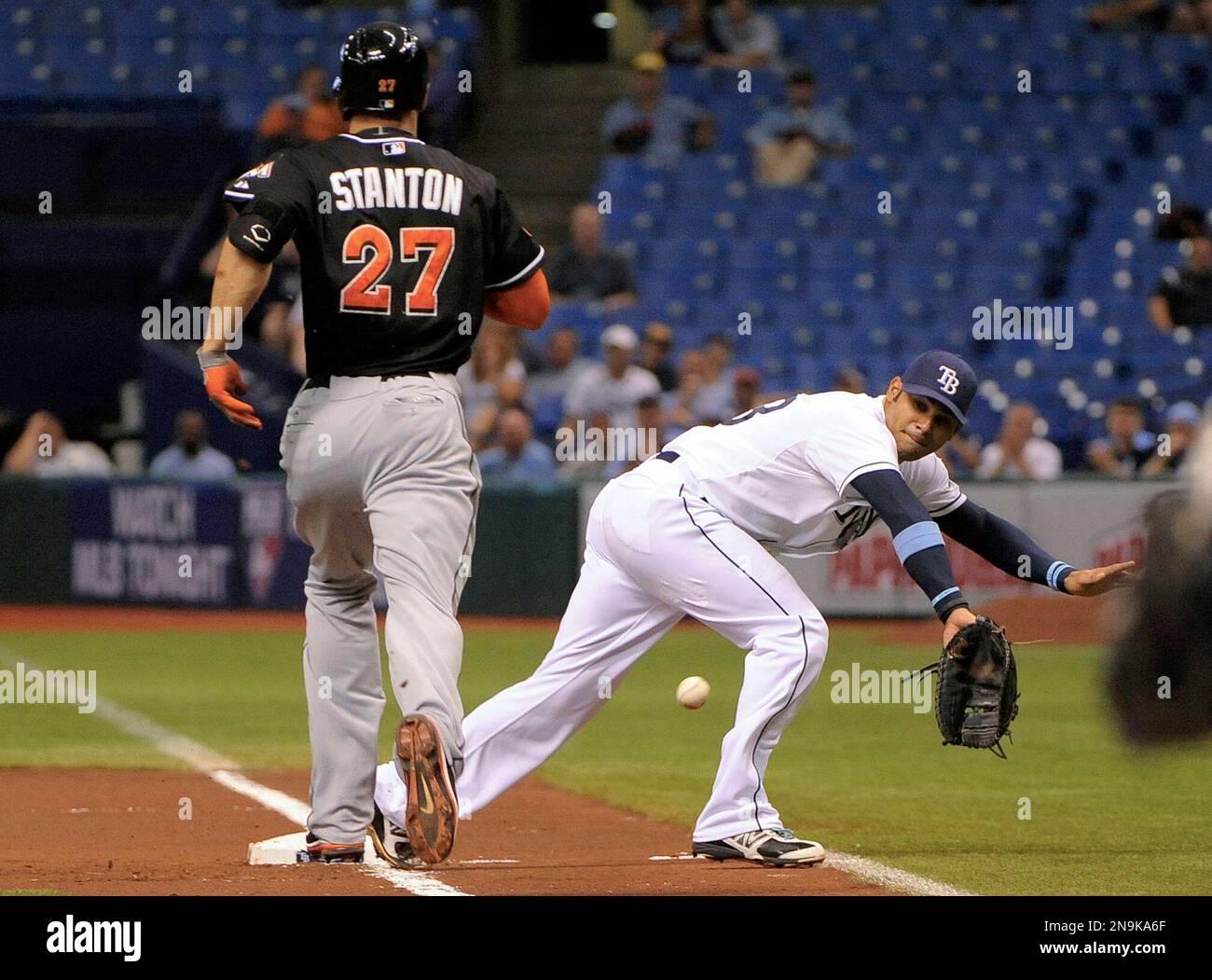 Tampa Bay Rays first baseman Carlos Pena, right, is unable to reach a throw from third baseman