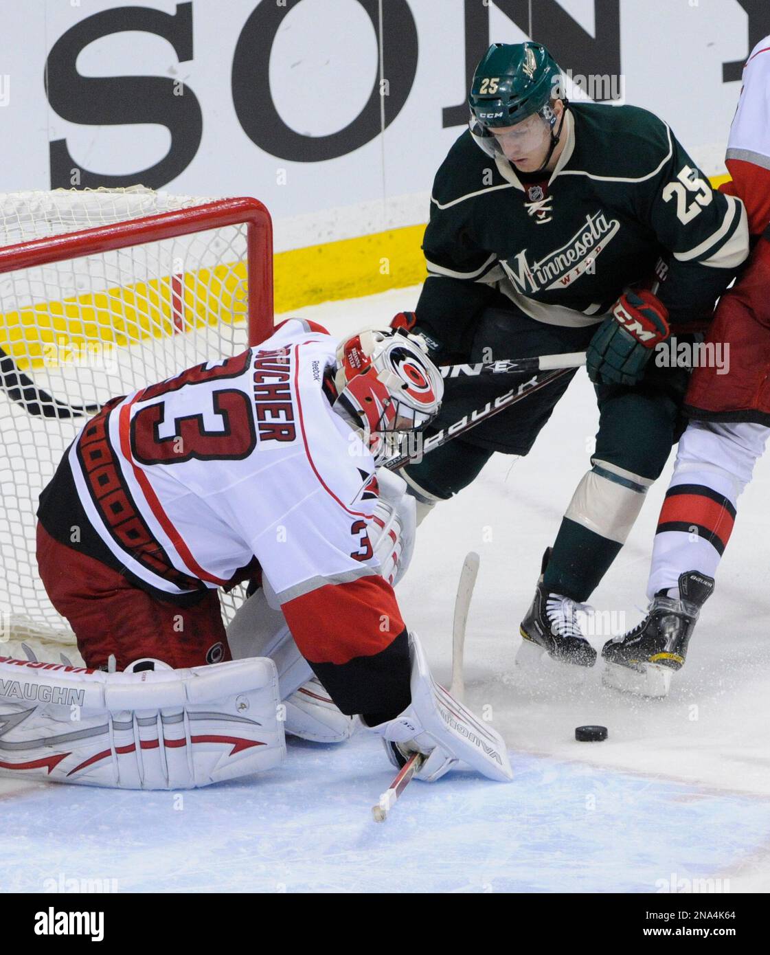 Carolina Hurricanes goalie Brian Boucher, left, and Minnesota Wild's