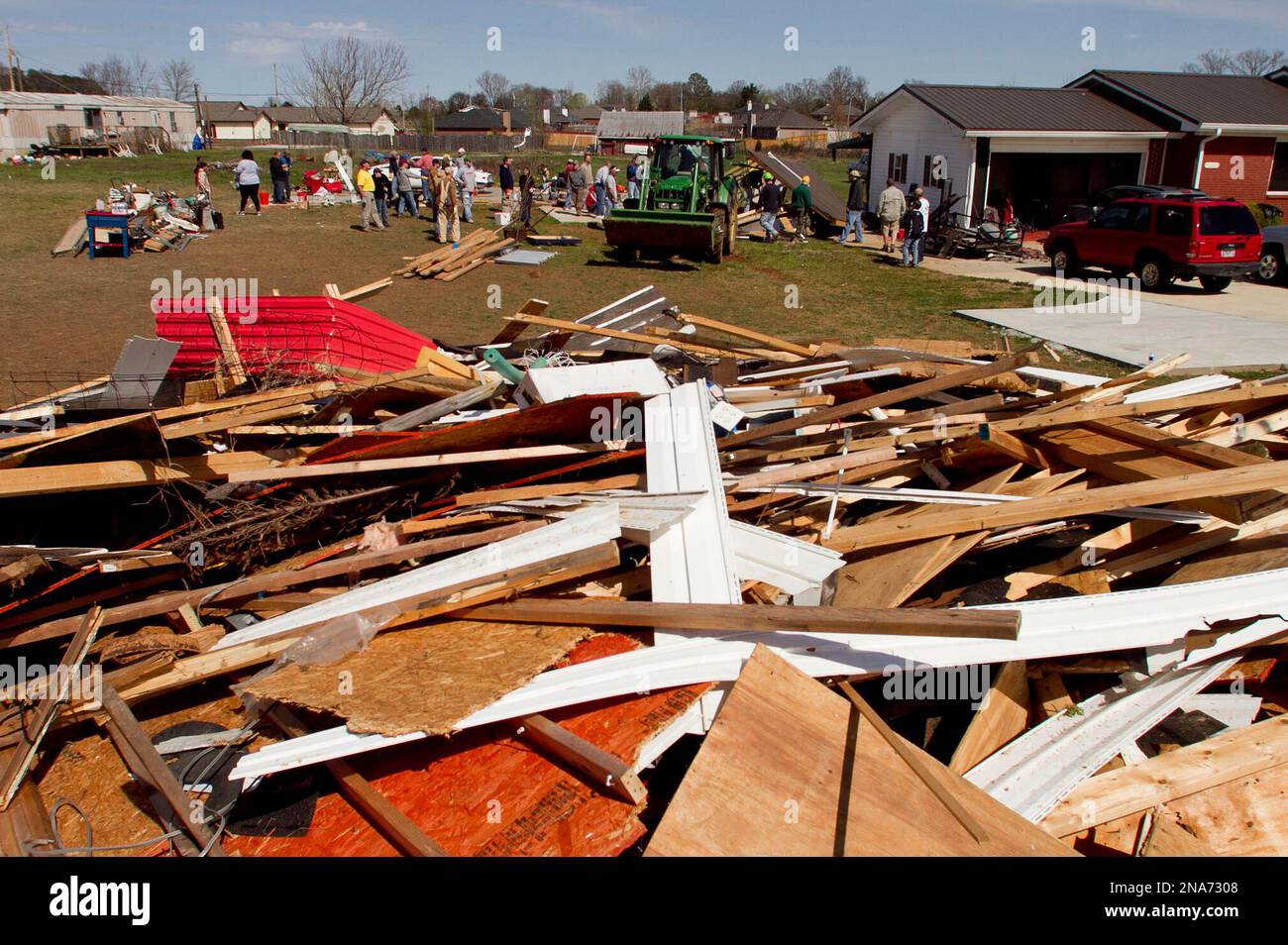 Family and friends begin the task of cleanup after a tornado left a