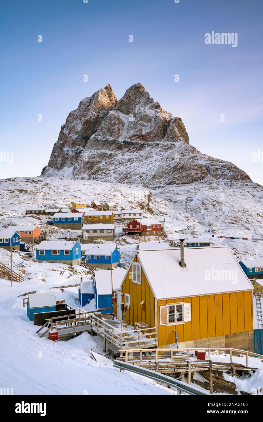 Cplourful casas en las laderas más bajas de la montaña Uummannaq en el noroeste de Groenlandia. Foto de stock