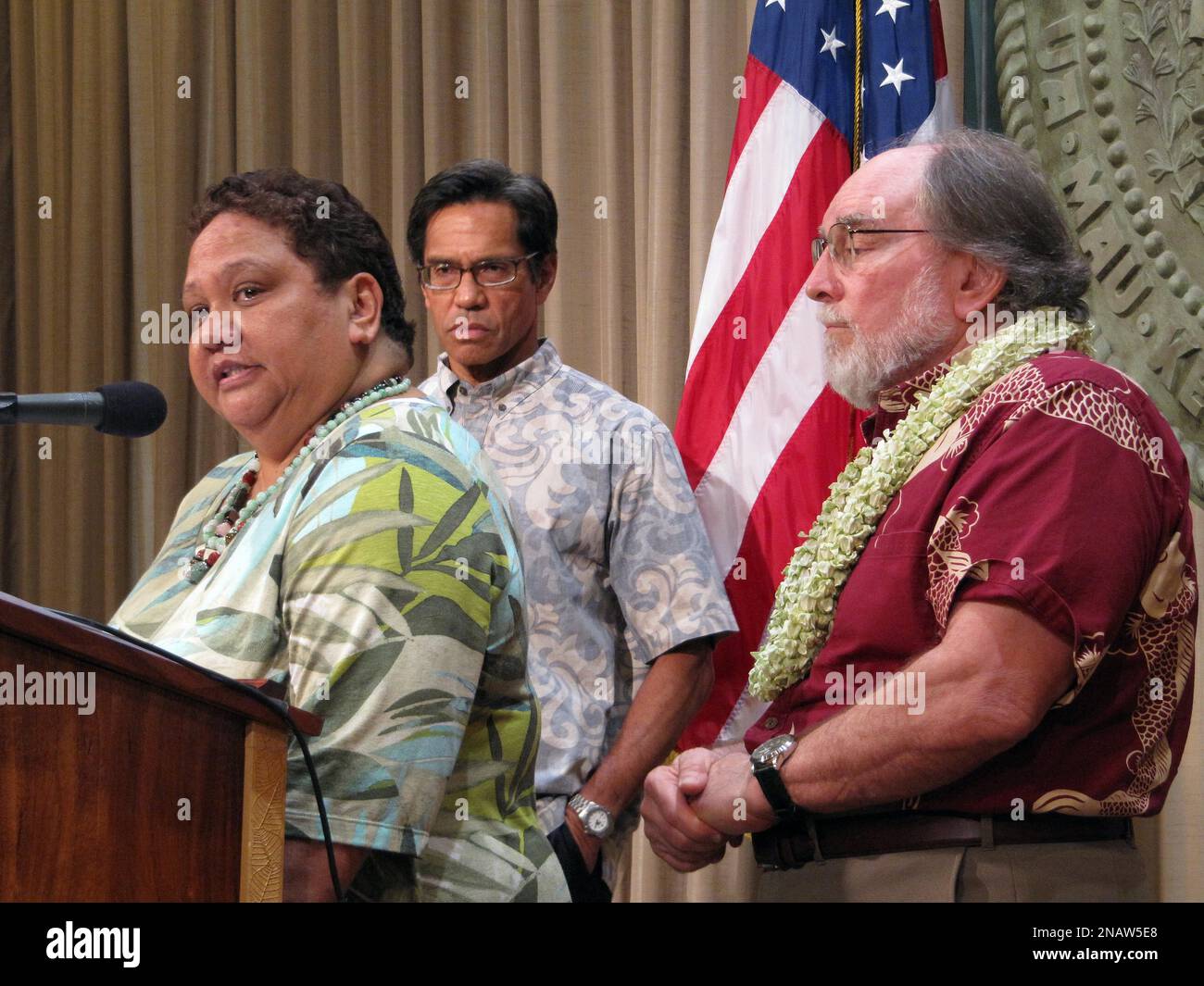 Office of Hawaiian Affairs Chairwoman Collette Machado, left, speaks at