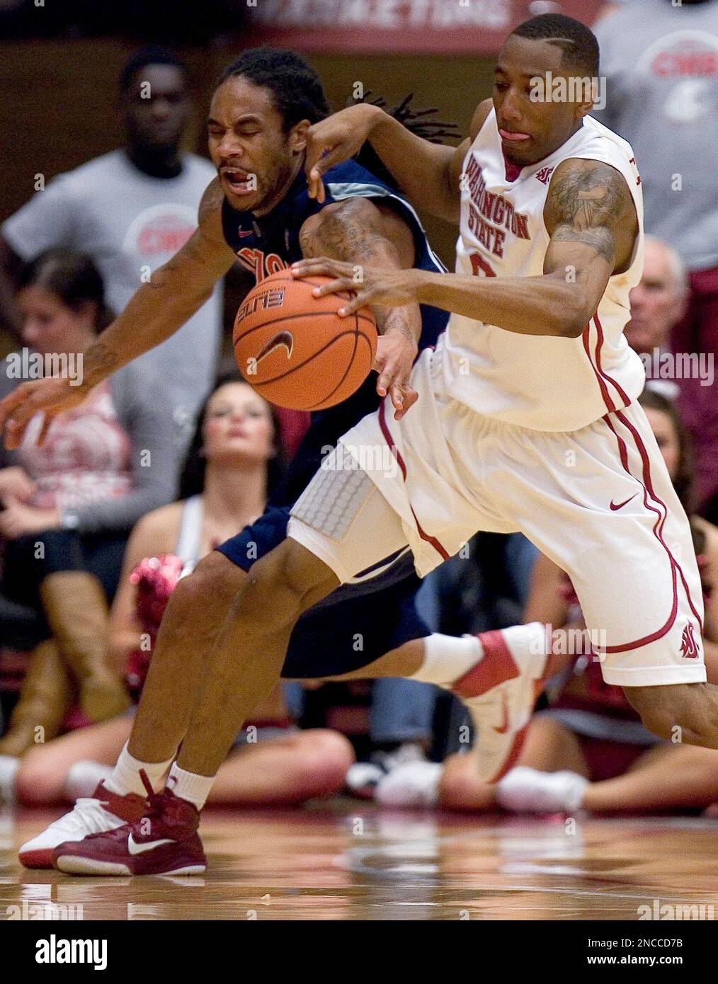 Washington State guard Marcus Capers, right, controls a loose ball from