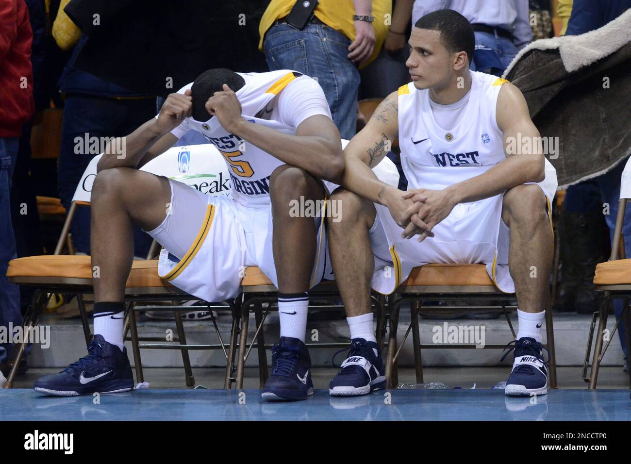 West Virginia's Kevin Jones, left, and Joe Mazzulla sit on the bench