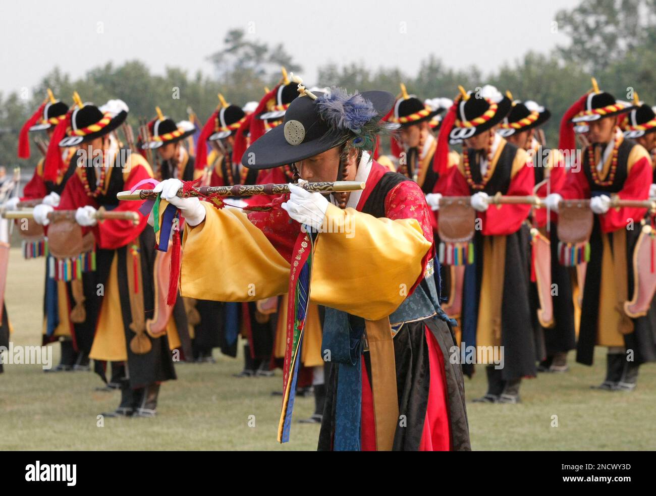South Korean honour guards wearing traditional military uniforms salute