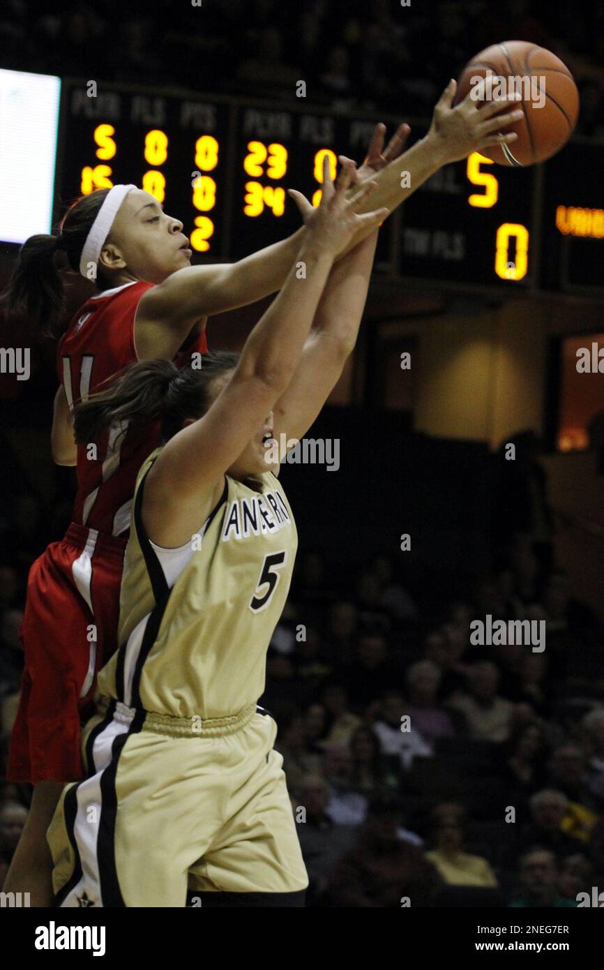 guard Meredith Mitchell, left,reaches over the back of