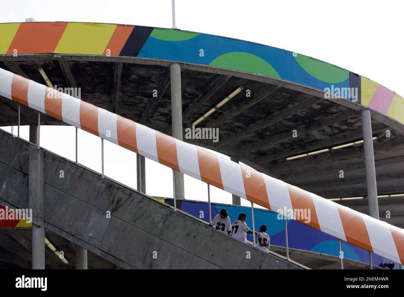 Football fans go up the escalator at Land Shark Stadium in Miami