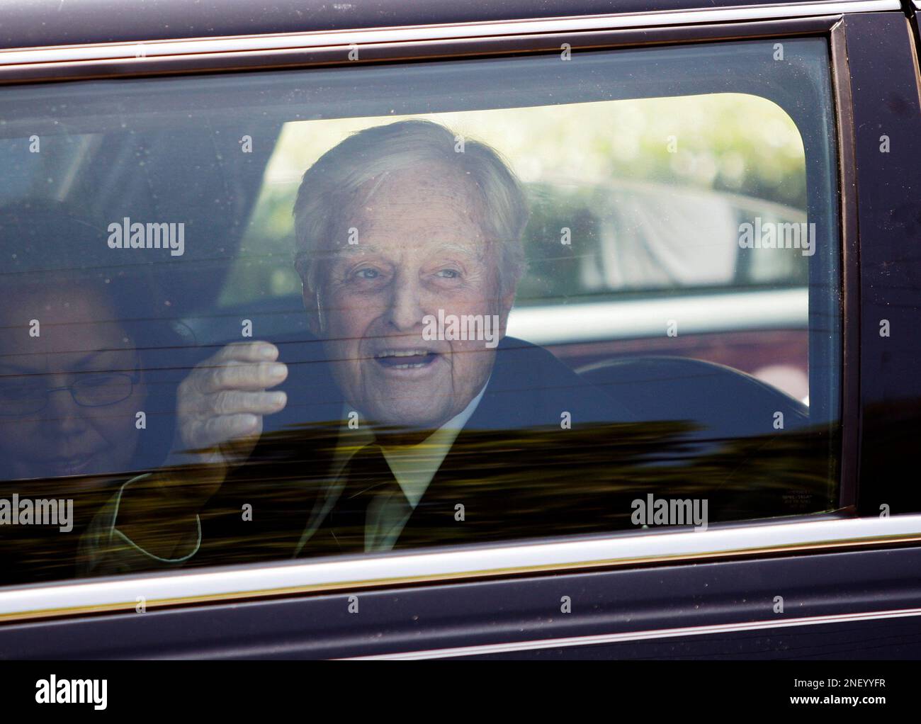 Sargent Shriver waves after the funeral for his wife Eunice Kennedy
