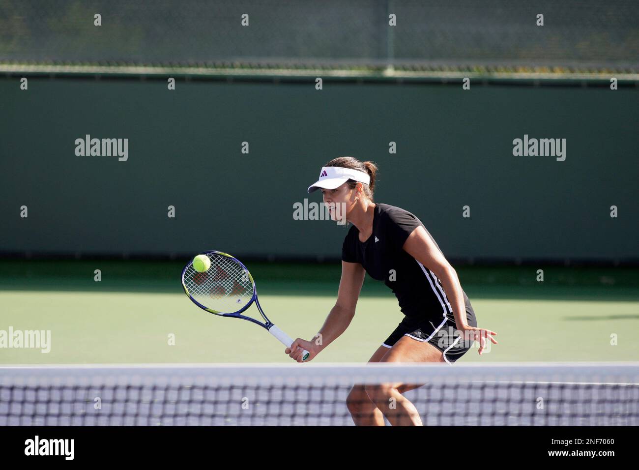 Ana Ivanovic, of Serbia, returns a volley during tennis practice for