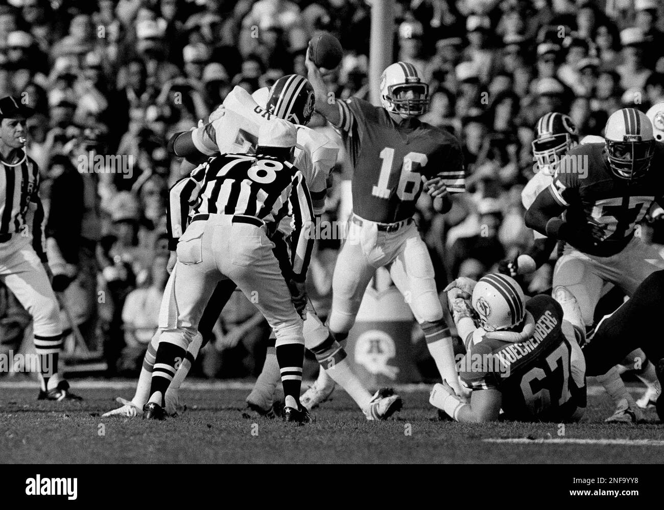 Miami Dolphins quarterback David Woodley (16) follows through on a