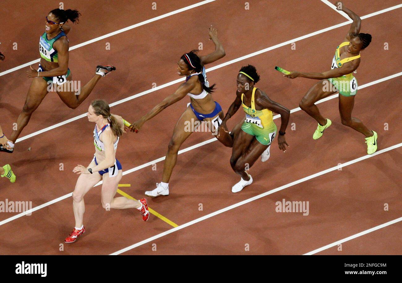 Jamaica's Kerron Stewart, second right, tries to receive a baton from