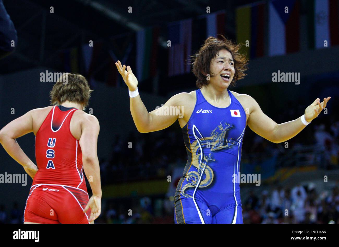 Kyoko Hamaguchi of Japan, in blue , reacts after winning against Ali  Bernard of the US for the bronze medal decider of 72kg women's freestyle  wrestling competition of the Beijing 2008 Olympics