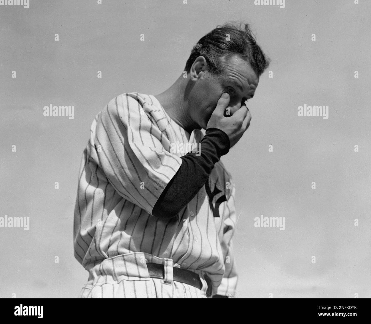 New York Yankees' Lou Gehrig, the "Iron Horse," wipes away a tear while
