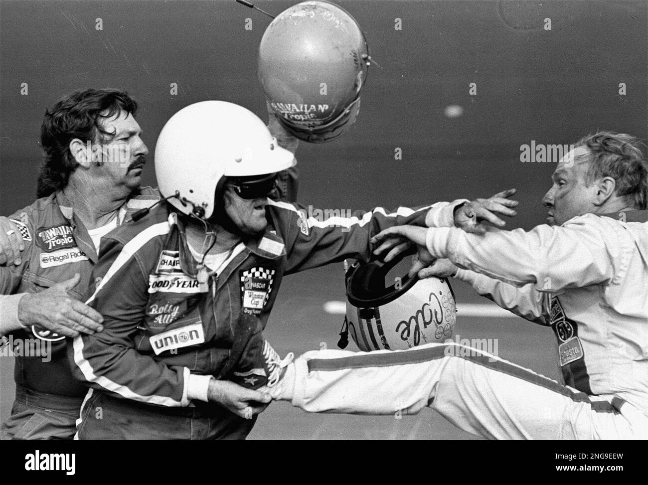 Bobby Allison holds race driver Cale Yarborough's foot after Yarborough