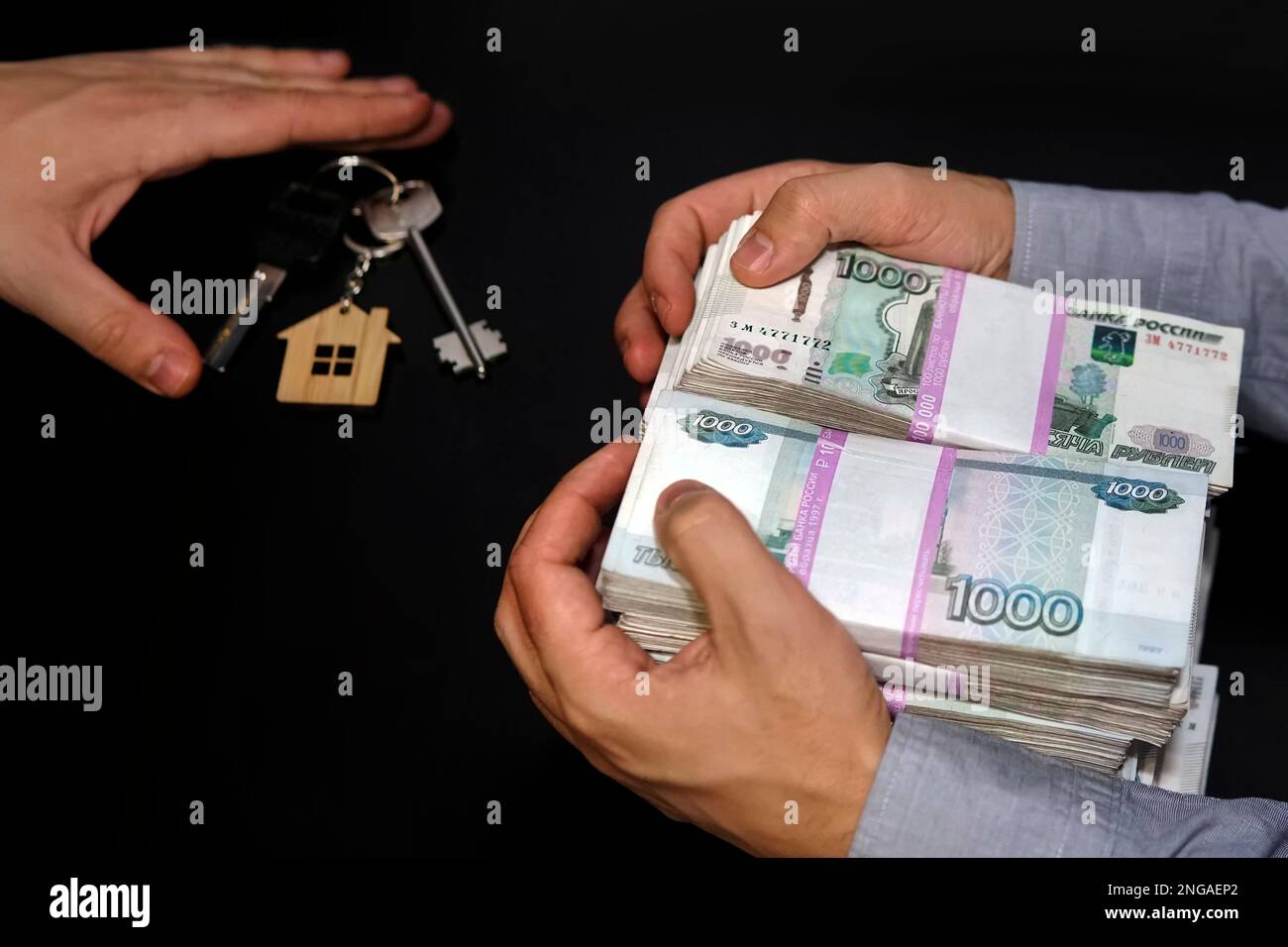 Billetes de rublos rusos y las llaves del apartamento en el cuadro negro. Venta inmobiliaria. El acuerdo para la venta de los apartamentos. Concepto. Foto de stock