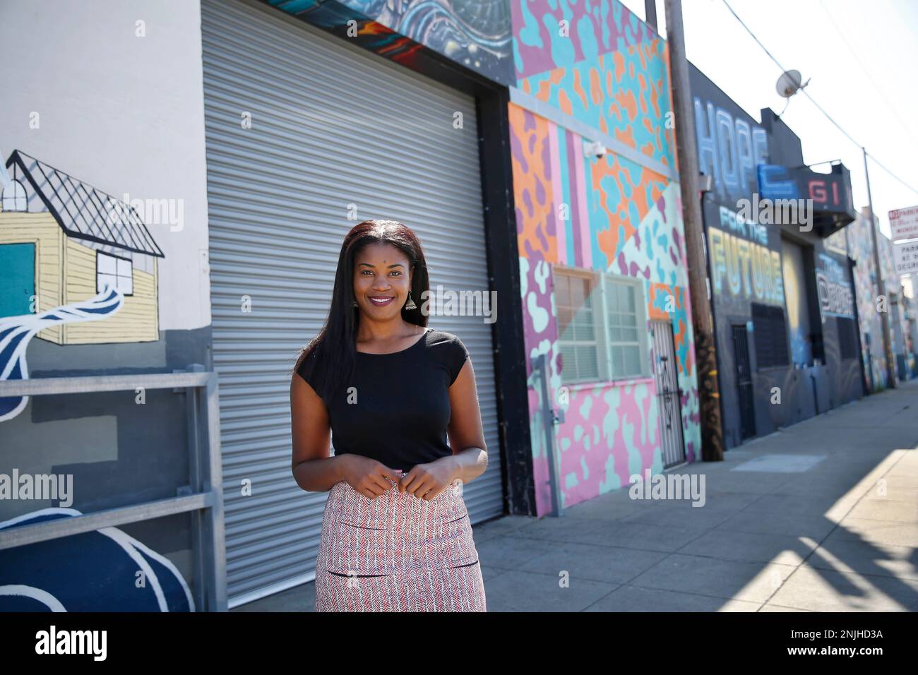 Tyra Fennell, Imprint City founder and CEO, stands for a portrait on Egbert Street in front of