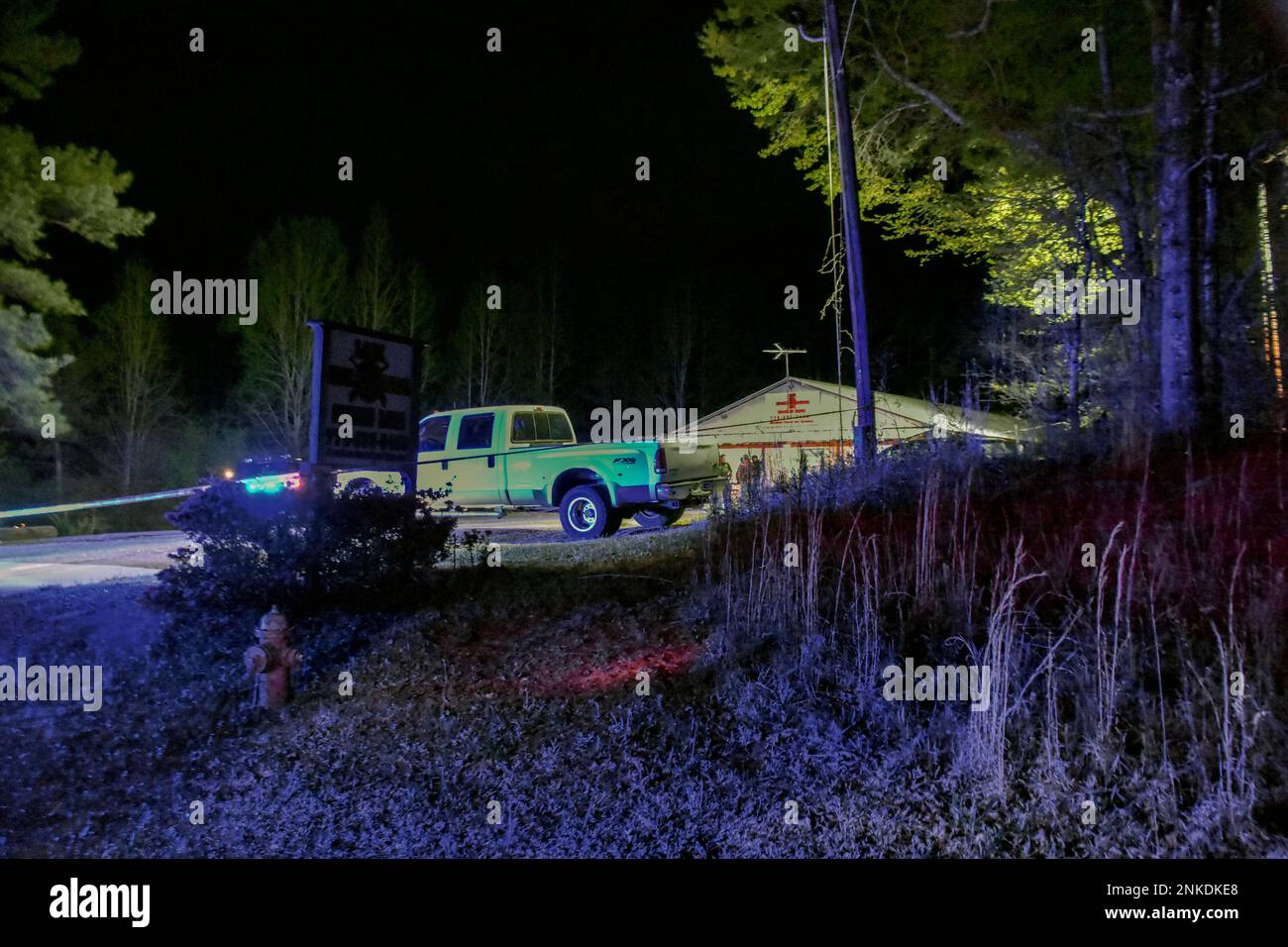 Law enforcement agents investigate the scene of a fatal robbery at Lock