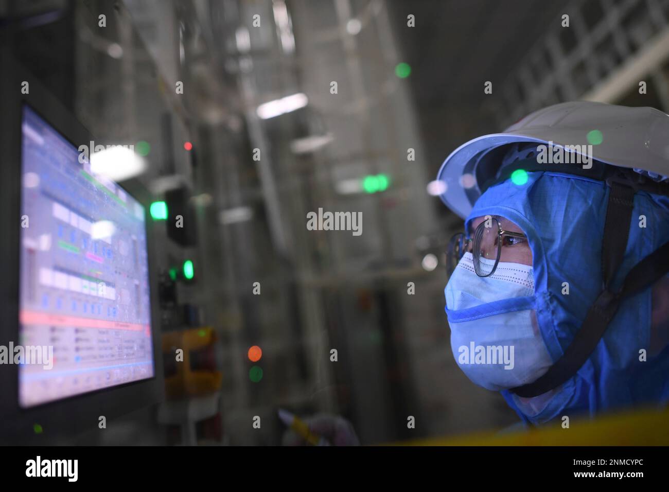 An employee works in a cleanroom of the production of LTPS (LowTemperature Polysilicon
