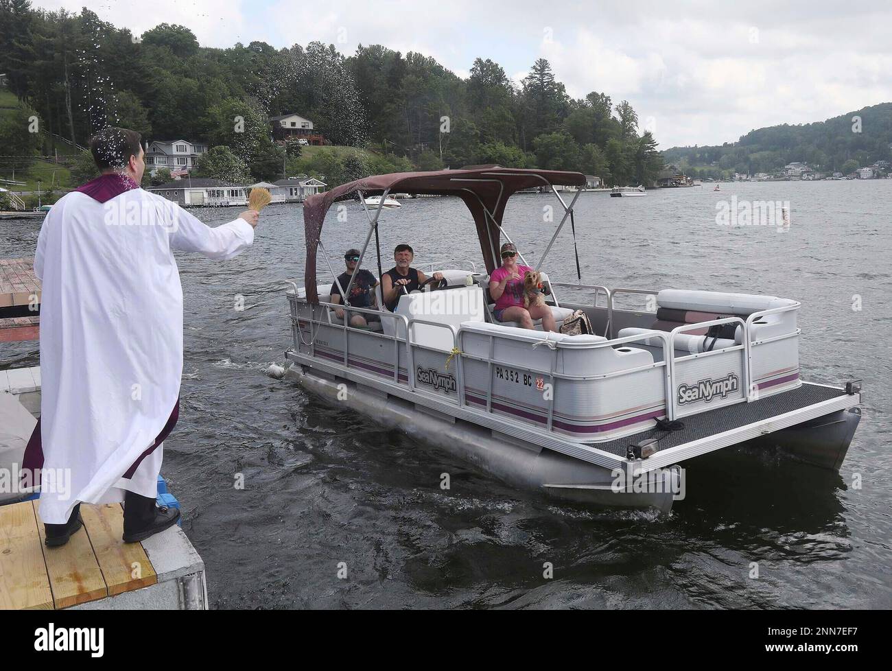 Pastor Daniel Toomey, of Our Lady of Victory Parish, sends a spray of