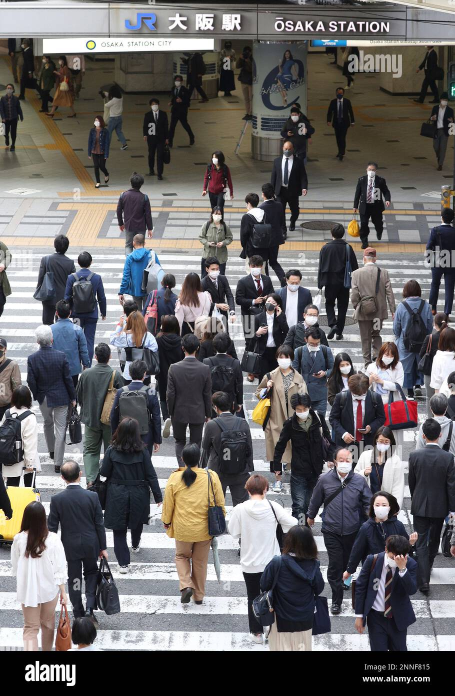 People wearing face masks are seen in front of Osaka Station during